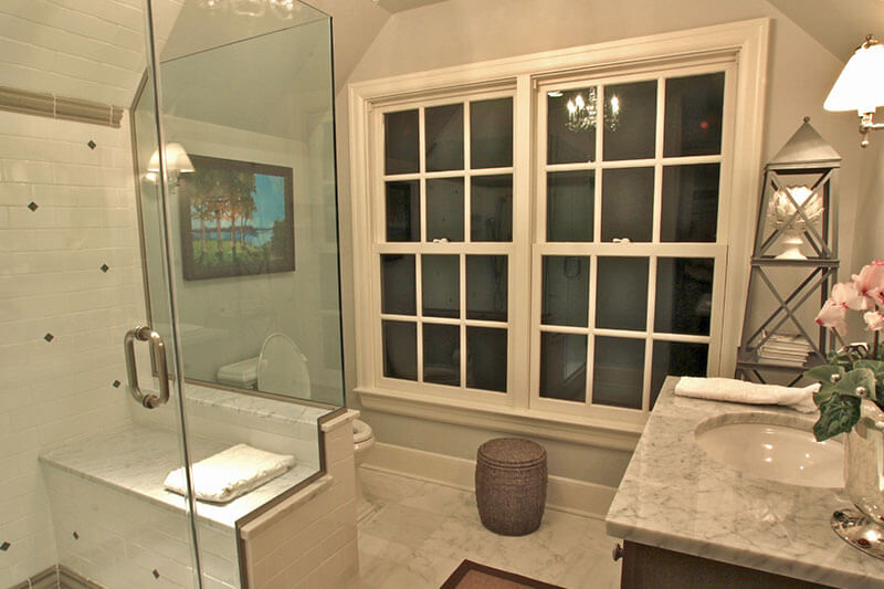 Beige Bathroom with Tiled Shower and Glass Shower Walls 