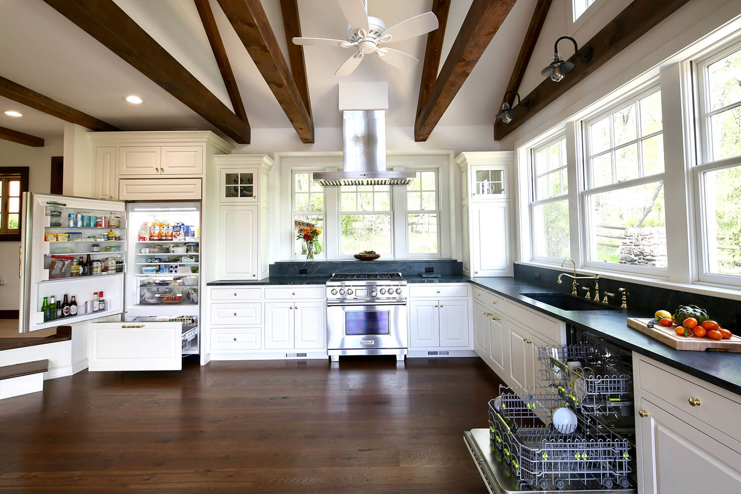 Kitchen with Blue Island, Turkish Style Blue Tiles, Stainless Steel Fridge and Hardwood Flooring