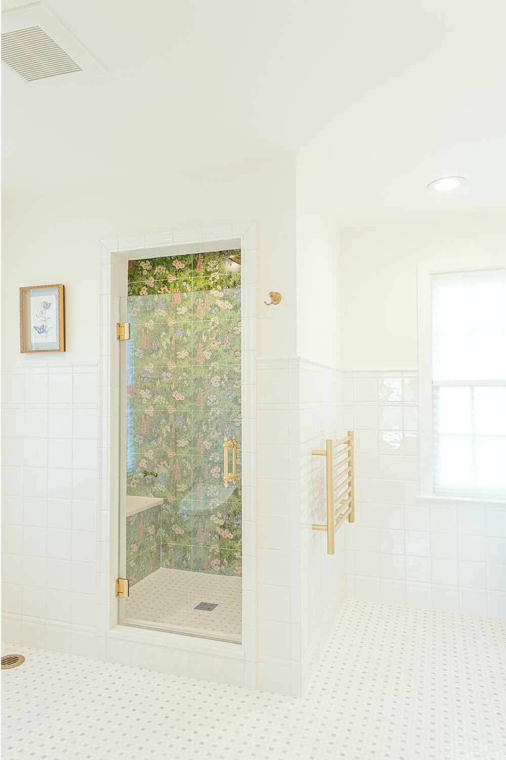 white-bathroom-with-floral-shower-door Elegant white bathroom with a floral shower door and gold accents